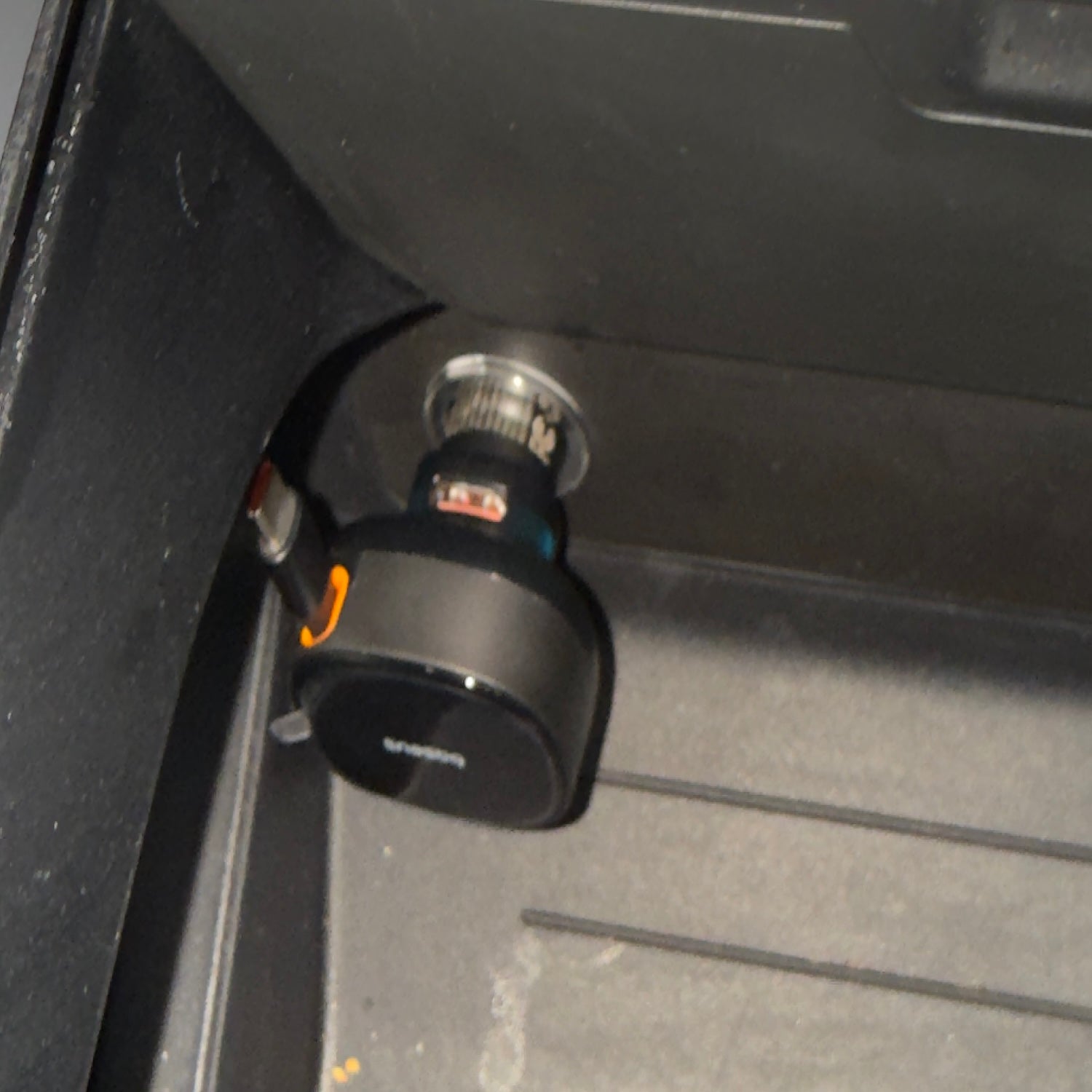 Dual USB-C car charger plugged into a vehicle power outlet