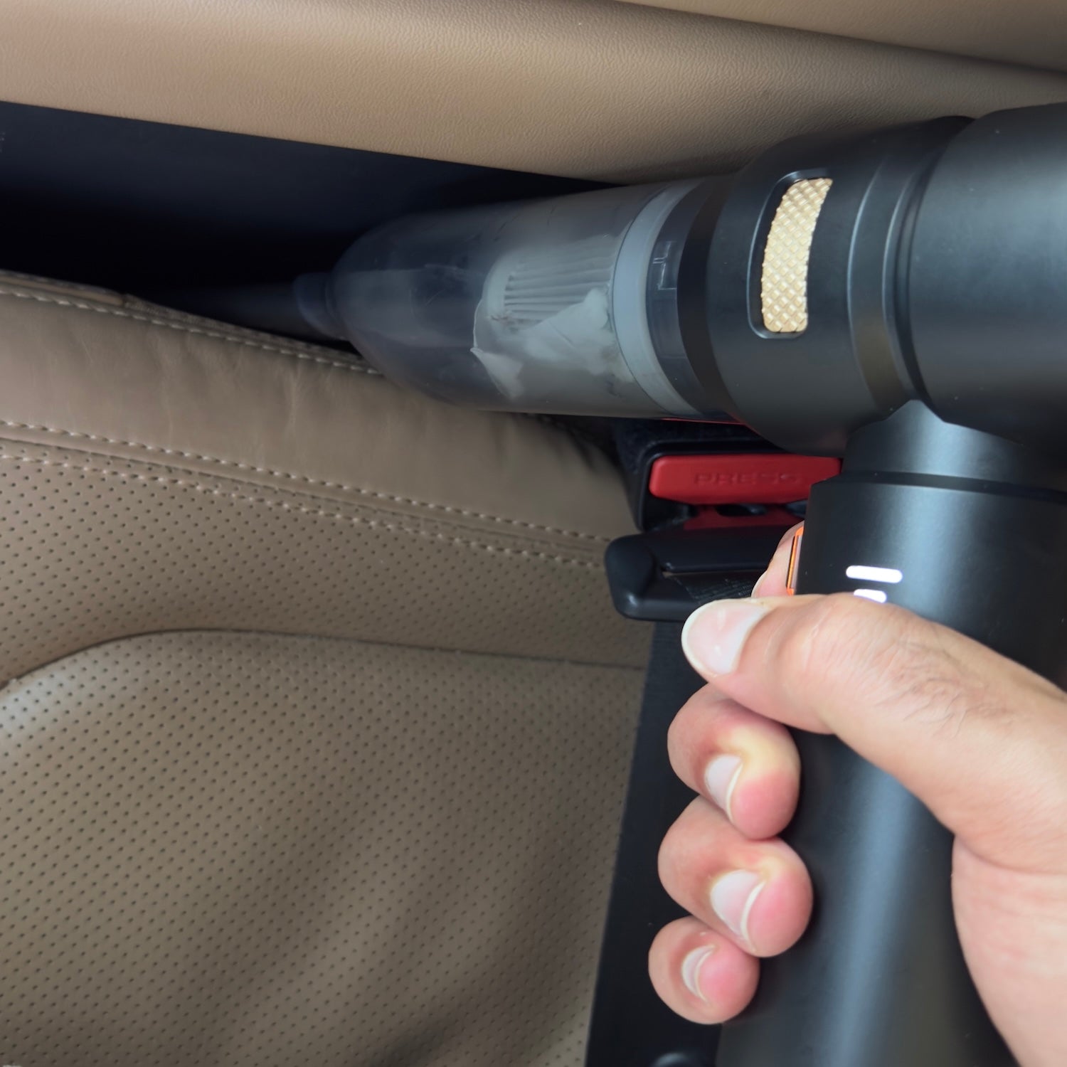 Cordless handheld car vacuum cleaning between the front seats 