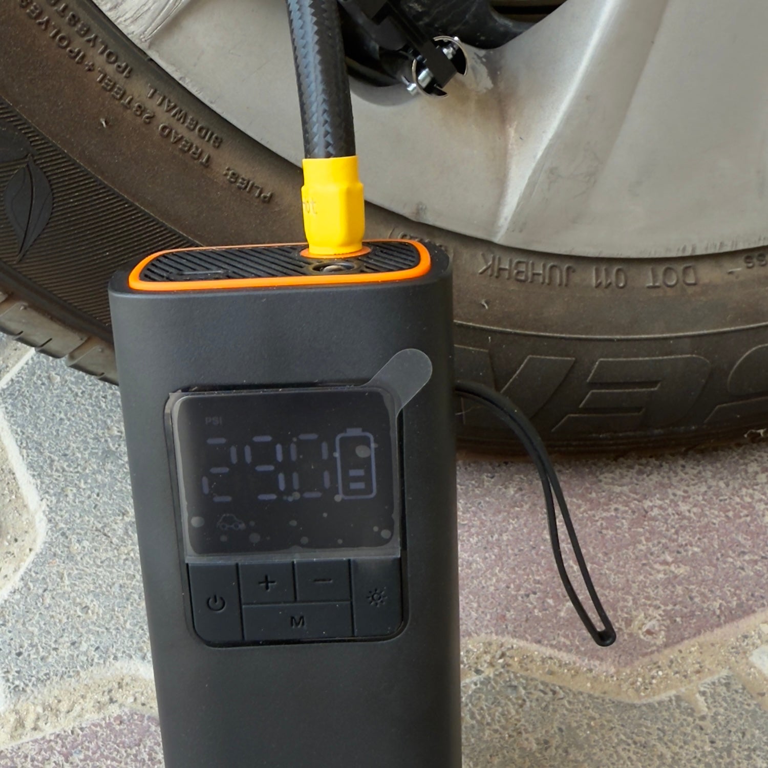 Portable tire inflator with digital pressure display showing the final tire pressure