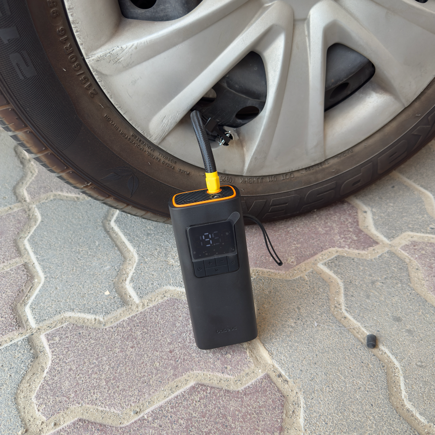 Cordless tire inflator inflating a car tire